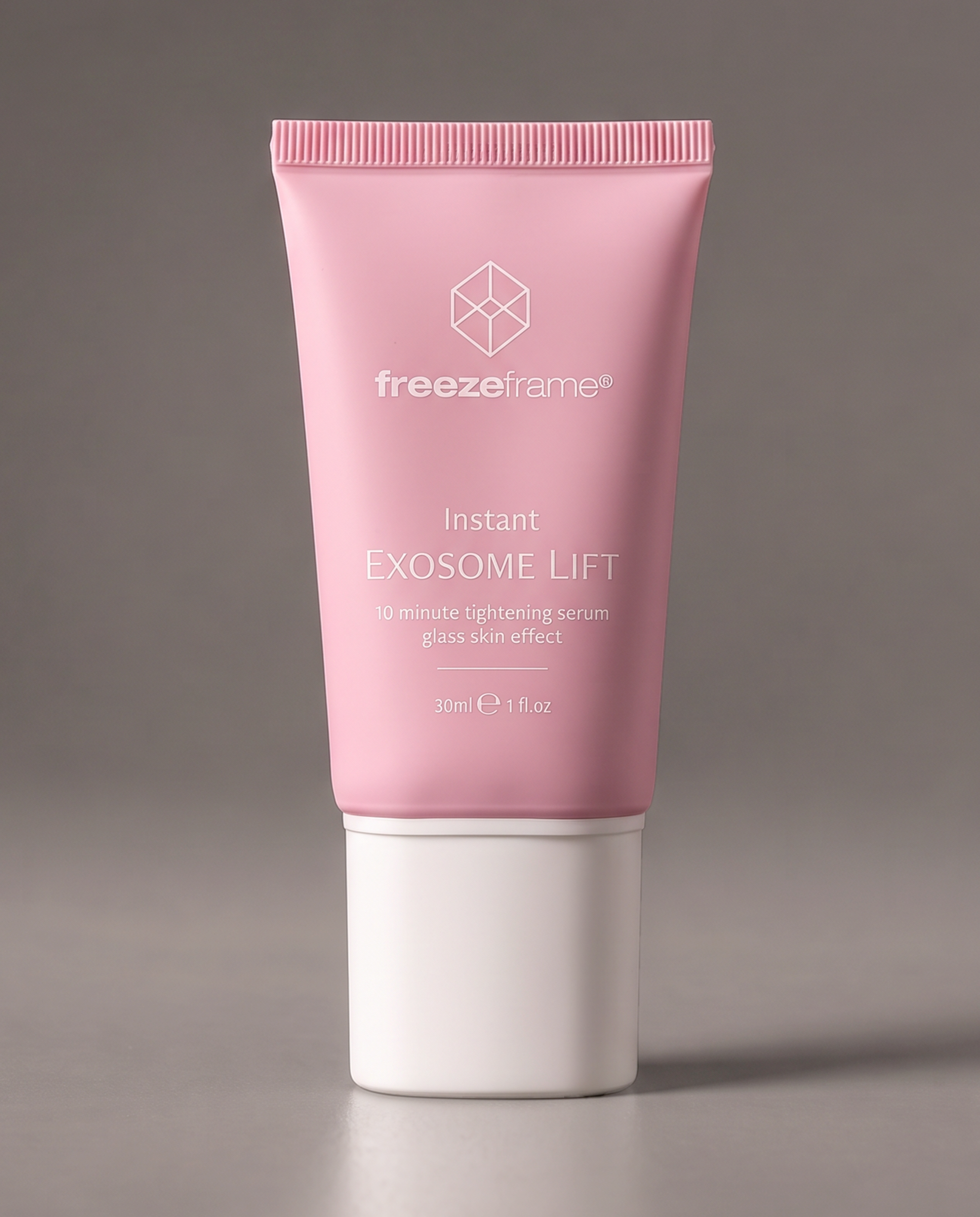freezeframe Instant EXOSOME LIFT 30ml facial tightening serum in a pink tube, designed to visibly tighten and smooth skin in 10 minutes for a firmer, glass skin appearance.