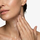Woman applying freezeframe NECK LIFT firming neck cream to her neck and décolletage, demonstrating skincare application to target neck wrinkles, sagging skin and fine lines.